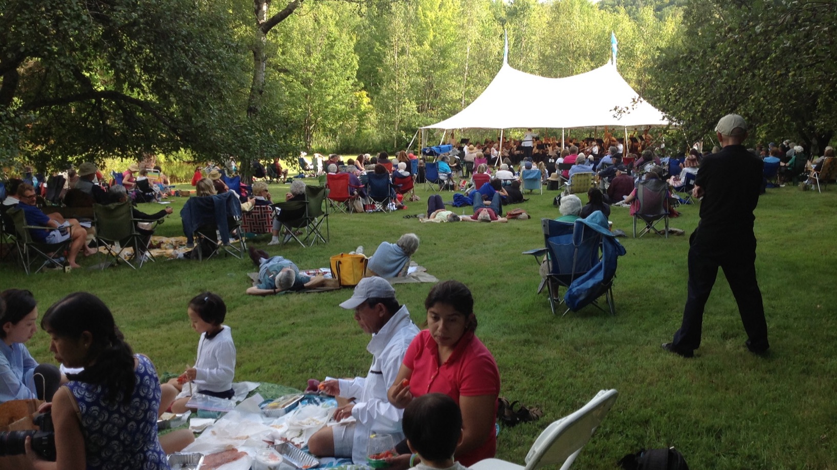 Families picnic on the lawn at Moose Meadow while enjoying the Vermont Philharmonic Pops.