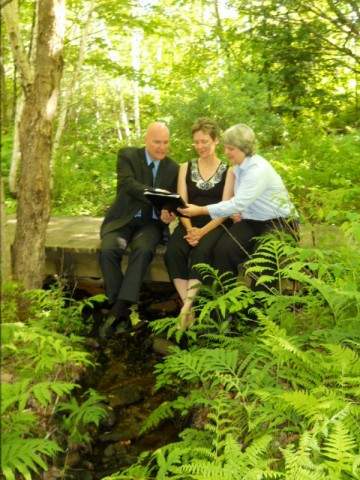 Moose Meadow Lodge Wedding Couple sitting on footbridge with Greg Trulson, Justice of the Peace